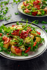 Fresh crispy Bacon, Potato salad with green vegetable on plate