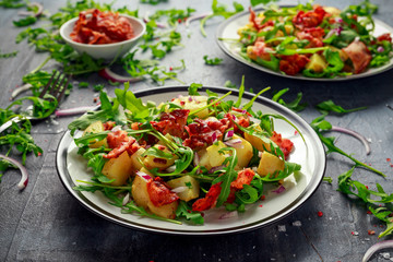 Fresh crispy Bacon, Potato salad with green vegetable on plate