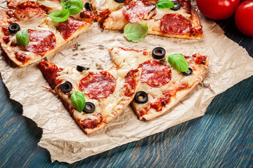 Slices of pizza pepperoni with olives