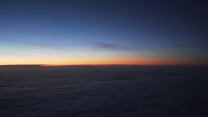 clouds in early morning during flight on a plane