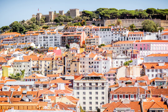 Cityscape view on the old town with castle hill on the horizon during the sunny day in Lisbon city, Portugal