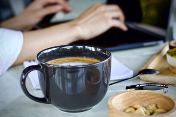 Woman writing working using laptop online