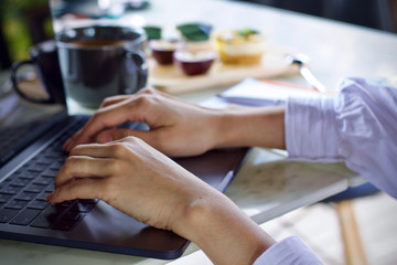 Obraz na płótnie Canvas Woman writing working using laptop online