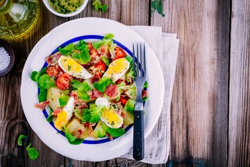 potato salad with eggs, lettuce,  tomatoes and bacon