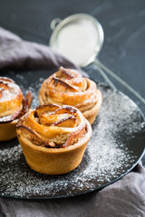 Fresh muffins with an apple