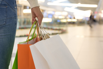 Close up of woman holding shopping bags in shopping mall