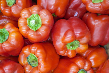 A pile of red bell peppers as background, texture
