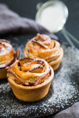 Fresh muffins with an apple
