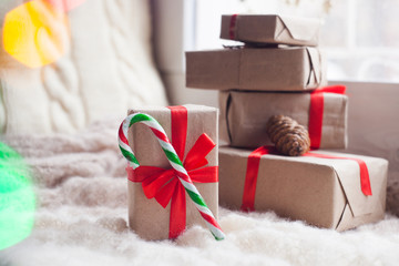 home, comfortable, festive atmosphere - boxes with gifts and candy cane, space for text.