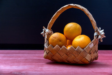 tangerines in a wicker basket