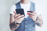Man with smartphone and credit card