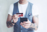 Man with credit card and smartphone