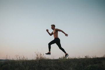 Fototapeta premium Sportsman running on nature