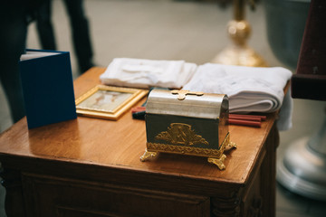 Golden religious utensils - Bible, cross, prayer book, missal. Details in the Orthodox Christian Church. Russia.