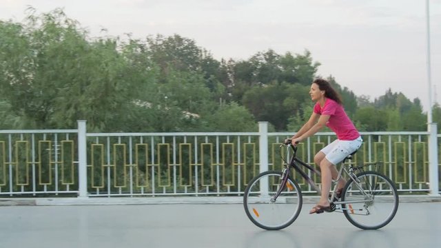 A woman is riding a bicycle.