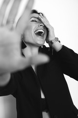 stylish crazy funny girl hiding from camera, laughing, white no isolated background