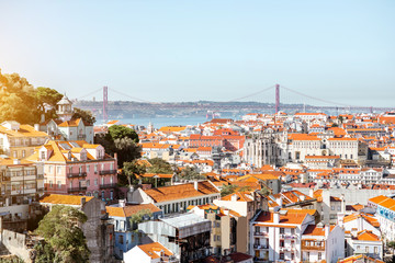 Cityscape view on the Lisbon city with famous bridge during the sunny day in Portugal