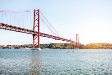 Landscape view on the 25th of April Bridge during the sunset in Lisbon city, Portugal