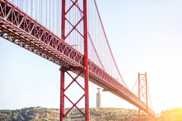 Fototapeta premium Landscape view on the 25th of April Bridge during the sunset in Lisbon city, Portugal