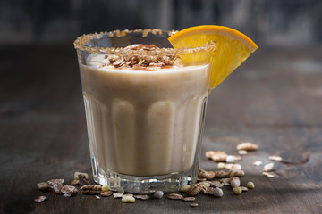 creamy cocktail with oats on dark background, closeup