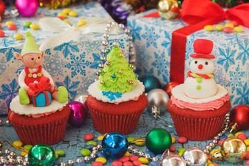 Christmas cupcakes with colored decorations made from confectionery mastic