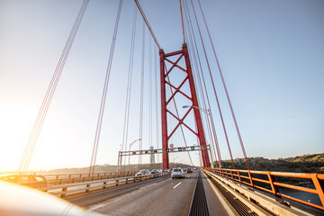 Fototapeta na wymiar Driving on the famous 25th of April bridge in Lisbon city, Portugal