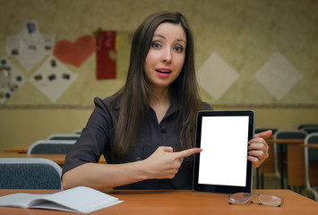 Education project presentation mock up. Homework. Girl student holds in hand a tablet computer with blank screen and points on it by her index finger.