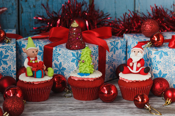 Christmas cupcakes with colored decorations made from confectionery mastic
