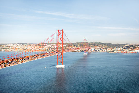 Landscape view on the Tagus river and the famous 25th of April Bridge during the morning light in Lisbon city, Portugal