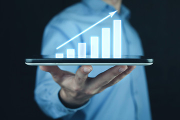 Businessman holding business graph.