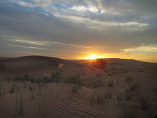 sunset over the sand dunes in the desert