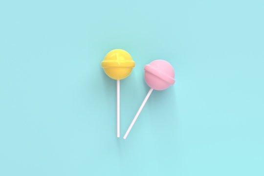 two lolipop yellow and pink on mint blue pastel background.sweet candy concept