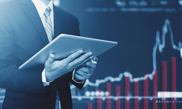 Businessman using digital tablet, raising graph background. Business growth, investment and invest in stock exchange market