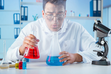 Funny mad chemist working in a laboratory