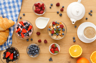 Continental breakfast with croissants and berries on natural wood