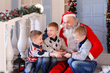Father Christmas joking with naughty boy. 