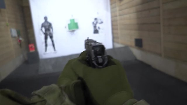A military man, goes and shoots a gun at a target. Action from the first person