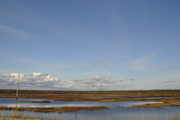 Cold autumn sky over rivers and lakes. Travelling. Tundra