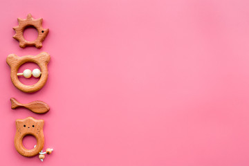 Simple handmade toys for newborn baby in shape of animals on pink background top view copyspace