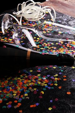 Party with champagne, glasses and confetti. New Year's Eve or birthday