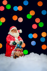 Santa Claus in red coat with gift bag
