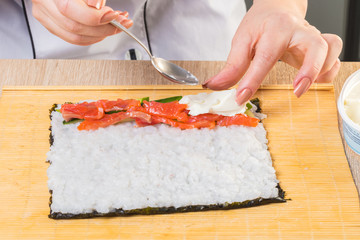 Chef prepares rolls, hands closeup