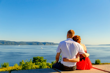 Fototapeta premium young loving couple people are looking at the sea and mountains