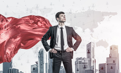 Concept of power and sucess with businessman superhero in big ci