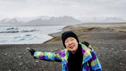 Asian senior woman travel to Iceland have fun retirement