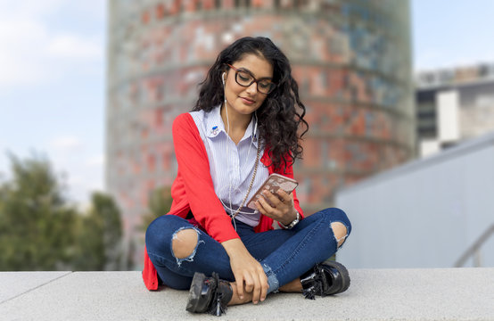 A young woman listening music on digital tablet  sitting