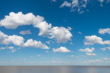 Beautiful blue sky with white clouds and Rio de La Plata horizon