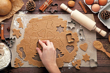 Baking christmas cookies on brown wooden table