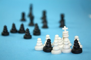 Black annd white chess pieces with black in distance, illegal migration metaphor conceptual theme.