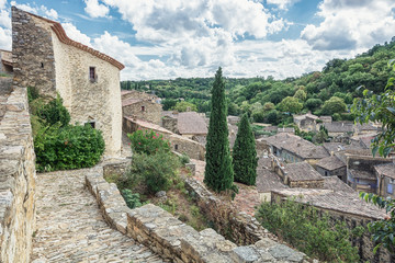 Fototapeta premium Top view of the rooftops of the village Saint Montan with the remains of an old city wall
